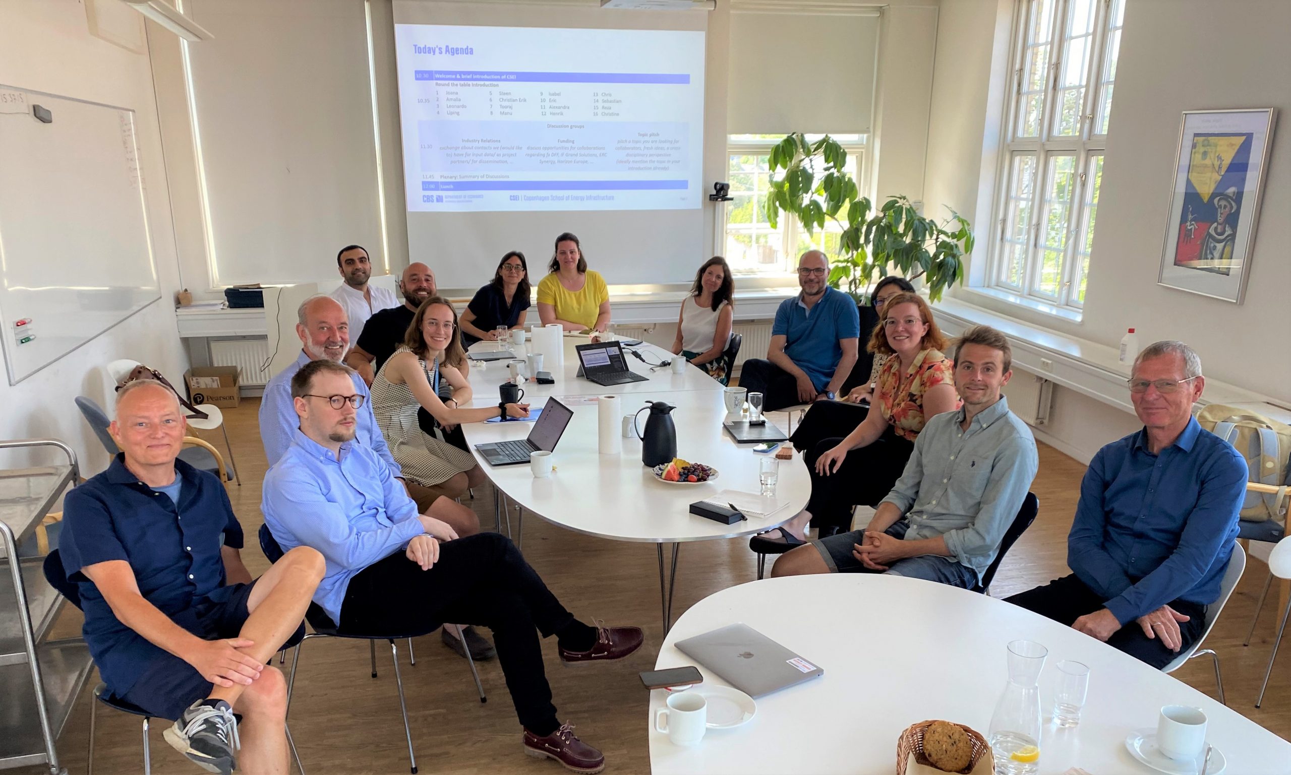 Photograph of the present energy researchers in a meeting room around a large table.